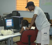 A biology teacher in Swaneng Hill School, Serowe, Botswana working with a student on an HIV/AIDS web site